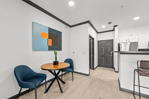 A modern dining area with a round table and chairs.