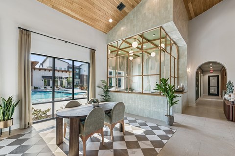A modern dining room with a checkered floor and a glass wall.
