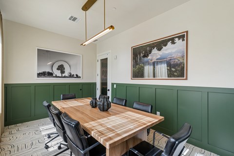 A conference room with a long table and chairs.
