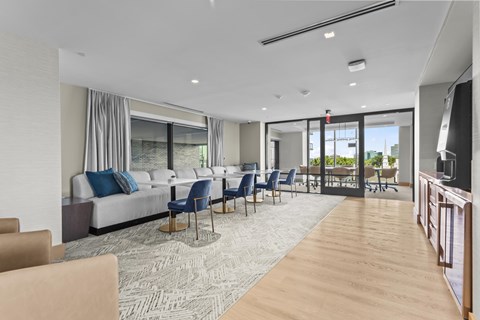 A modern living room with a long couch and chairs.