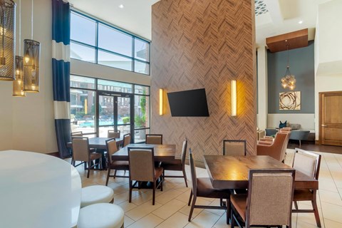 A modern dining room with a wooden patterned wall and a large table with chairs.