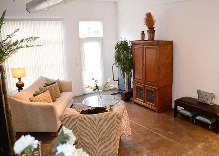 a living room filled with furniture and a large window