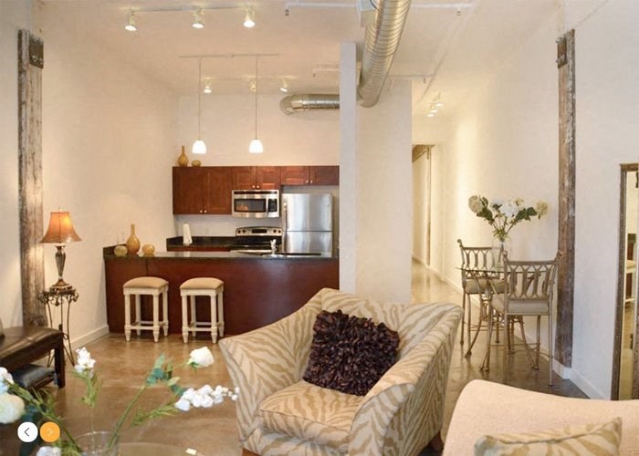 a living room with a couch a chair and a table