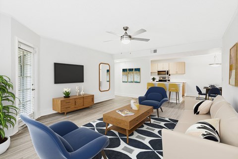 A living room with a blue chair and a wooden coffee table.