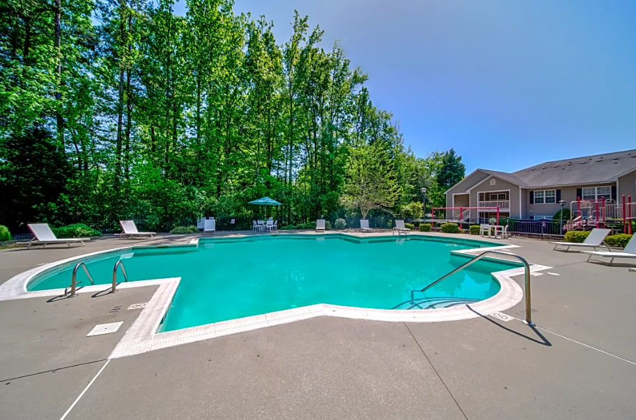 our apartments offer a swimming pool with a building in the background