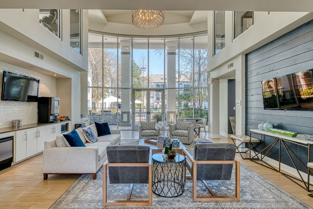 a living room with couches and chairs and a television