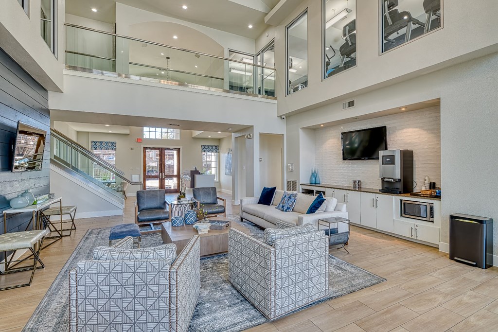 a living room with couches and chairs and a television
