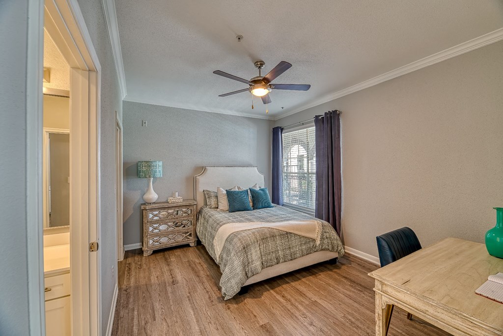 a bedroom with a bed and a ceiling fan