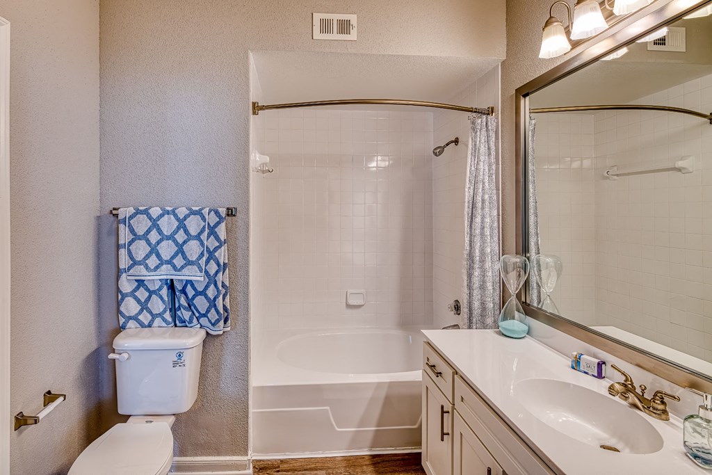 a bathroom with a shower toilet and sink