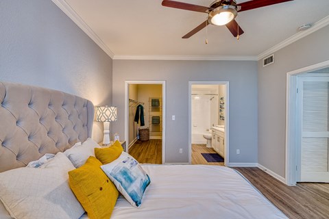 a bedroom with a large bed and a ceiling fan