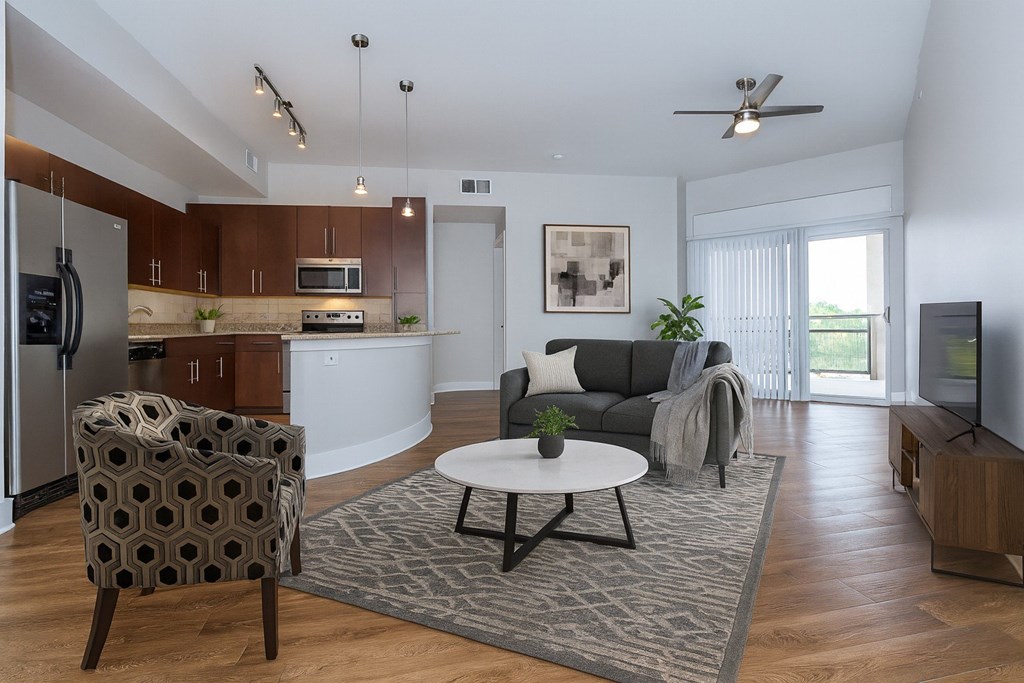 A modern living room with a grey sofa and a patterned armchair.