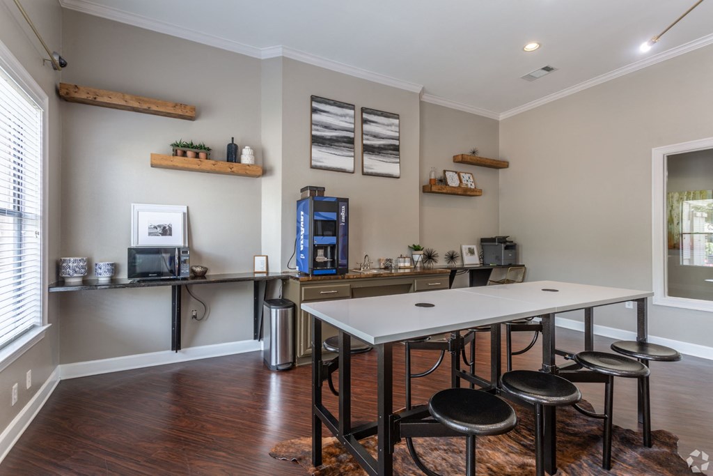 a dining room with a white table and stools