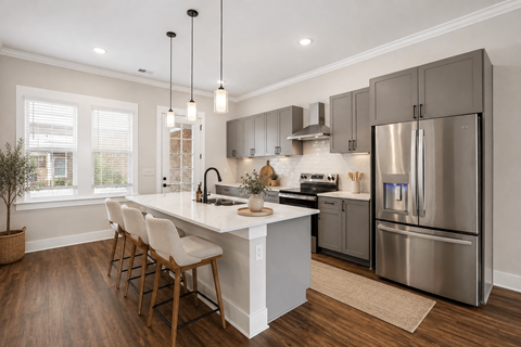 A modern kitchen with a large island and stainless steel appliances.