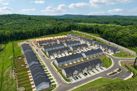 A bird's eye view of a residential area with houses and roads.