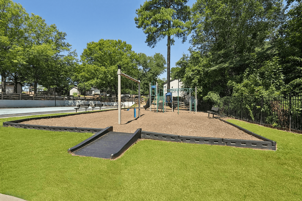 A playground with a swing set and a seesaw.