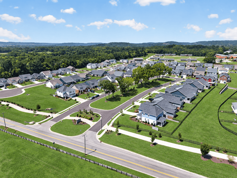 A suburban neighborhood with houses and a road.