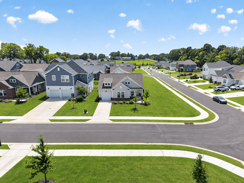 A suburban neighborhood with houses and a clear sky.