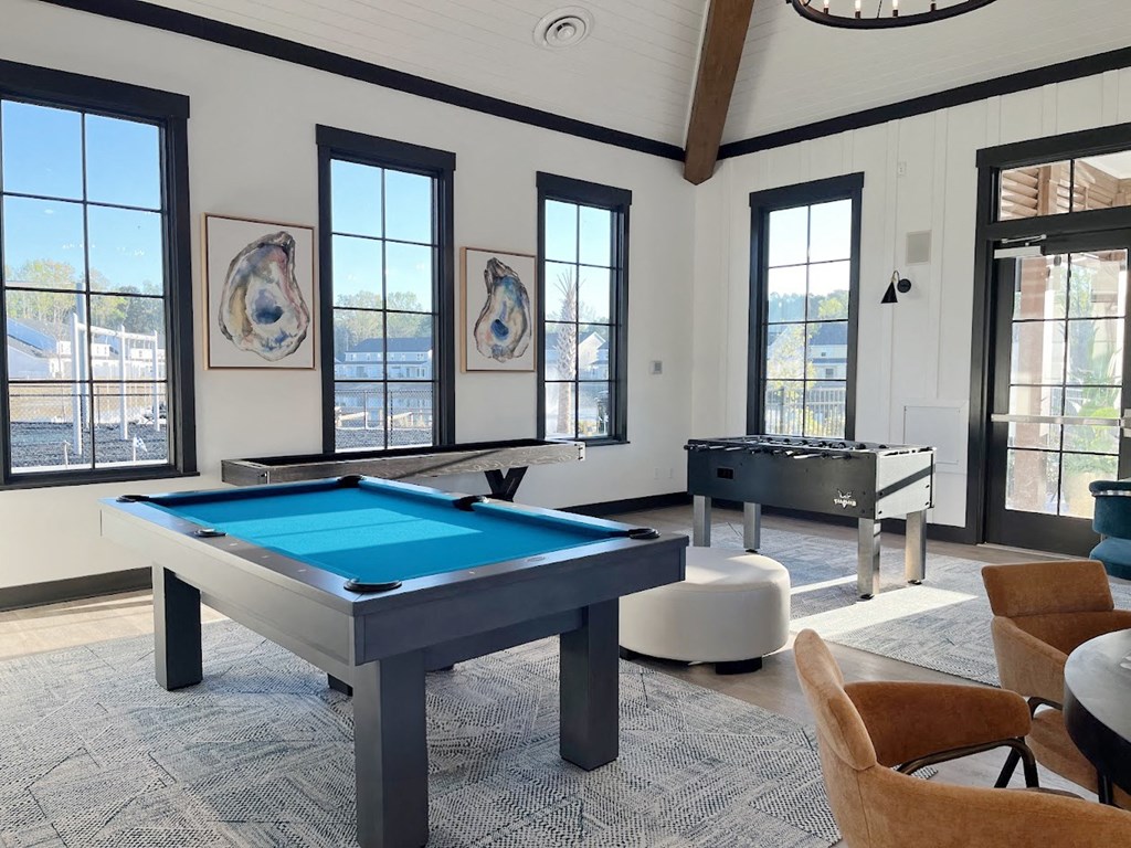 A pool table in a room with a view of the city.