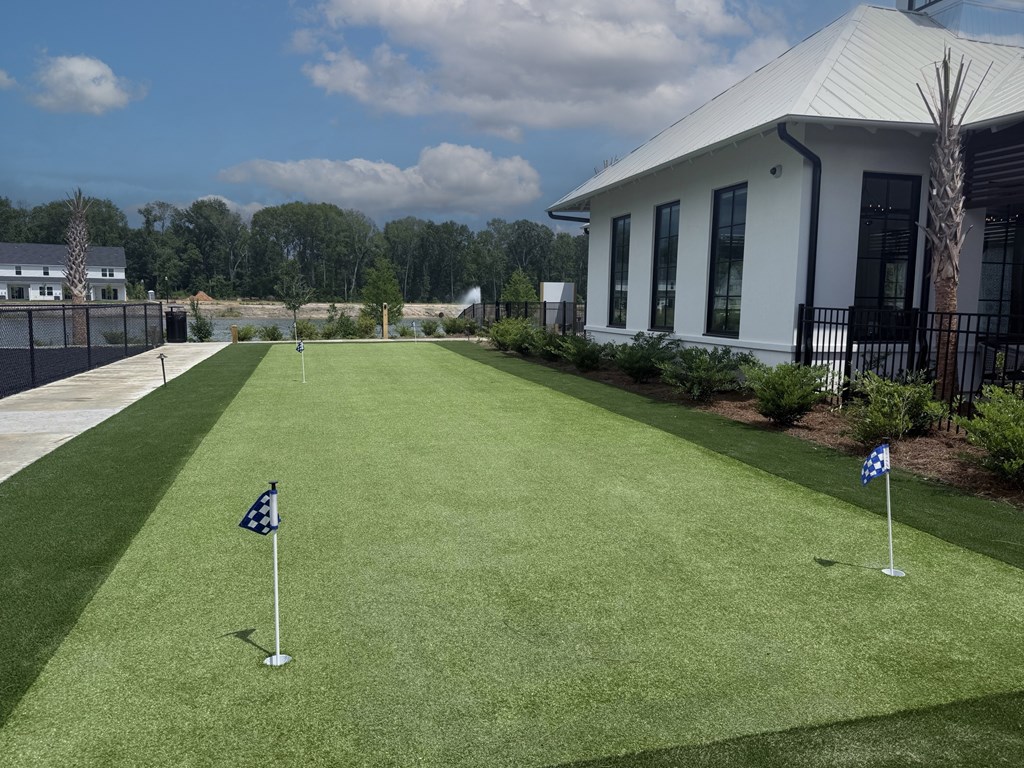 A golf course with a blue flag on the green.