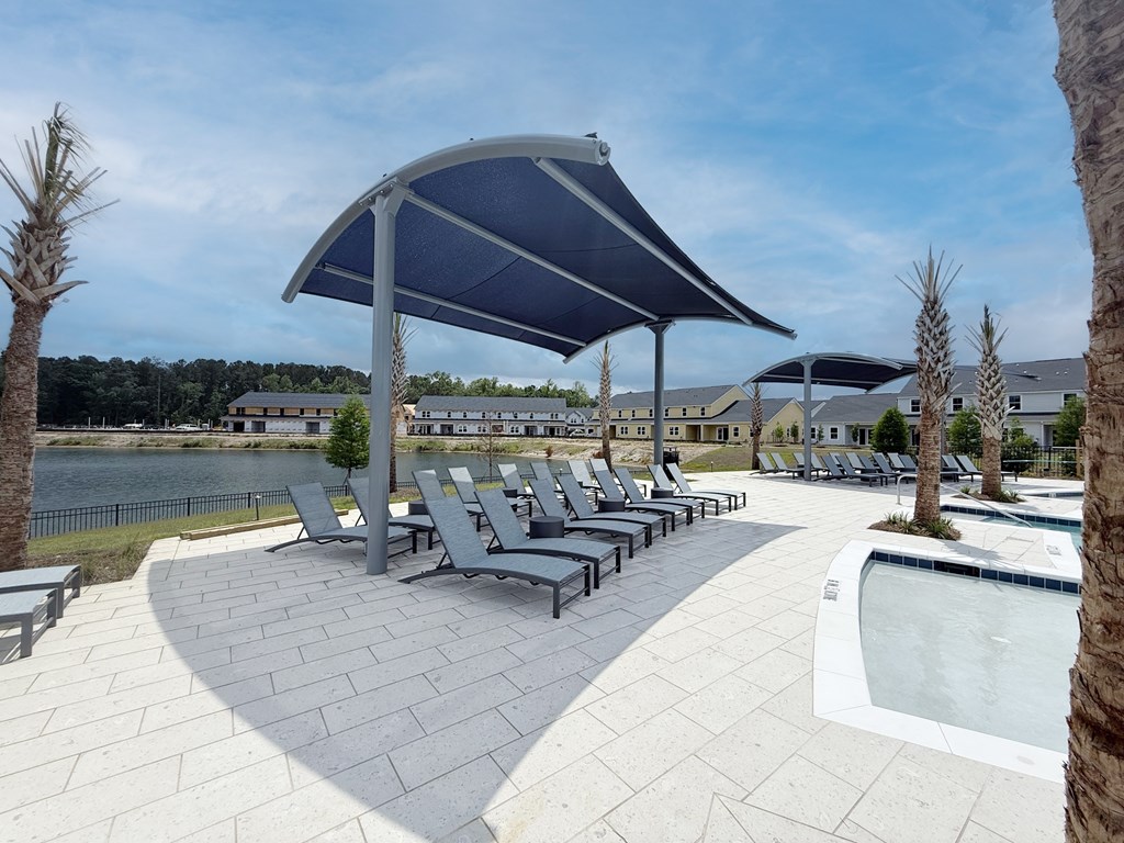 A large outdoor area with a pool and sun loungers.