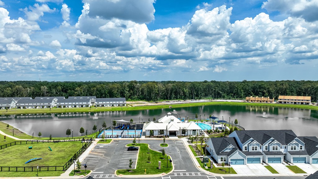 A large building with a pool in front of it.