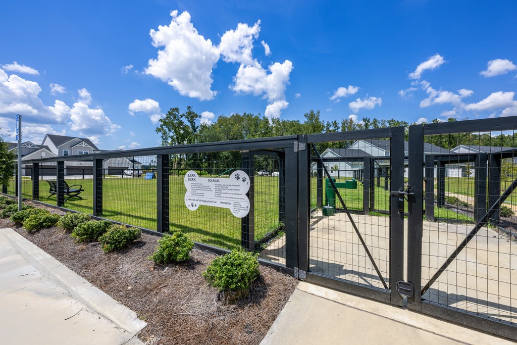 A black fence with a sign attached to it.