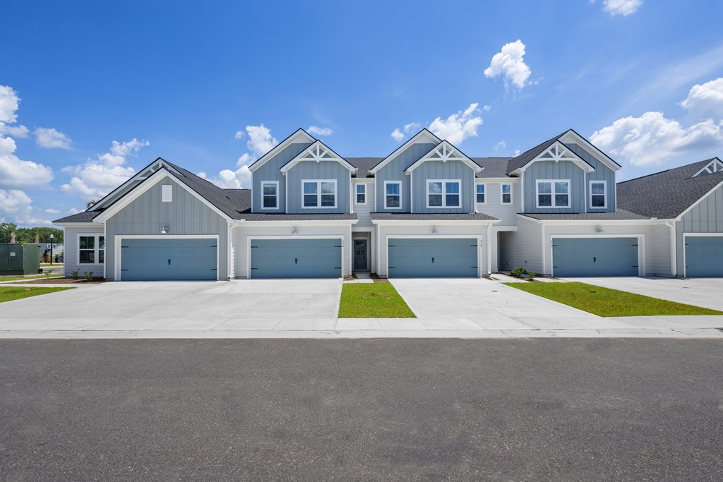 A large, modern house with a grey garage door.