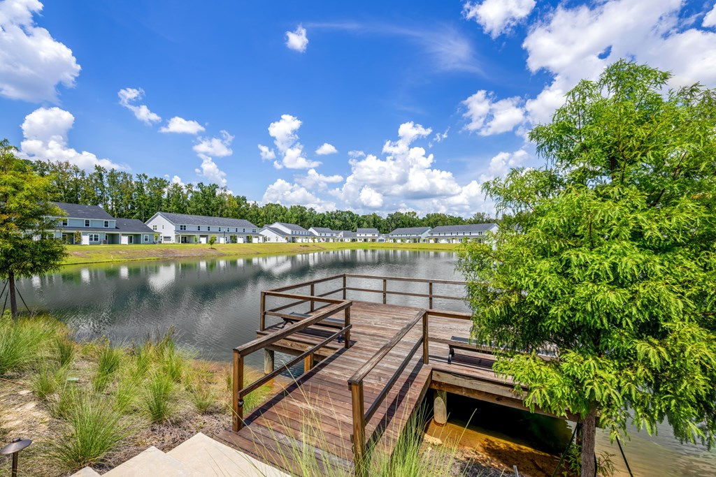 A wooden dock extends into a calm body of water.