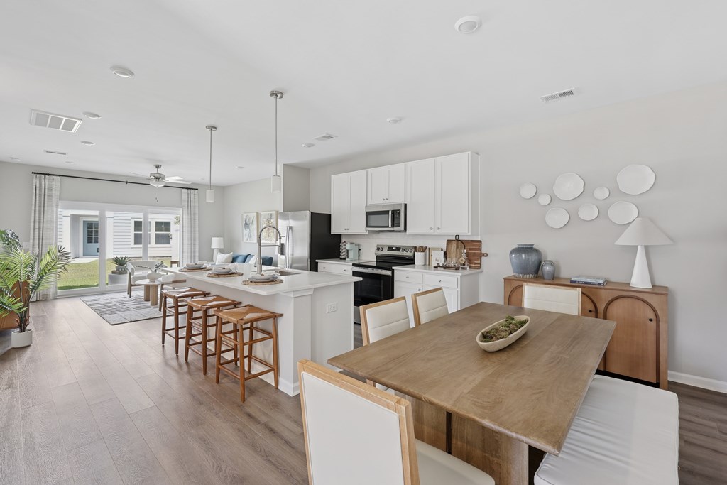 A modern kitchen with a dining table and chairs.