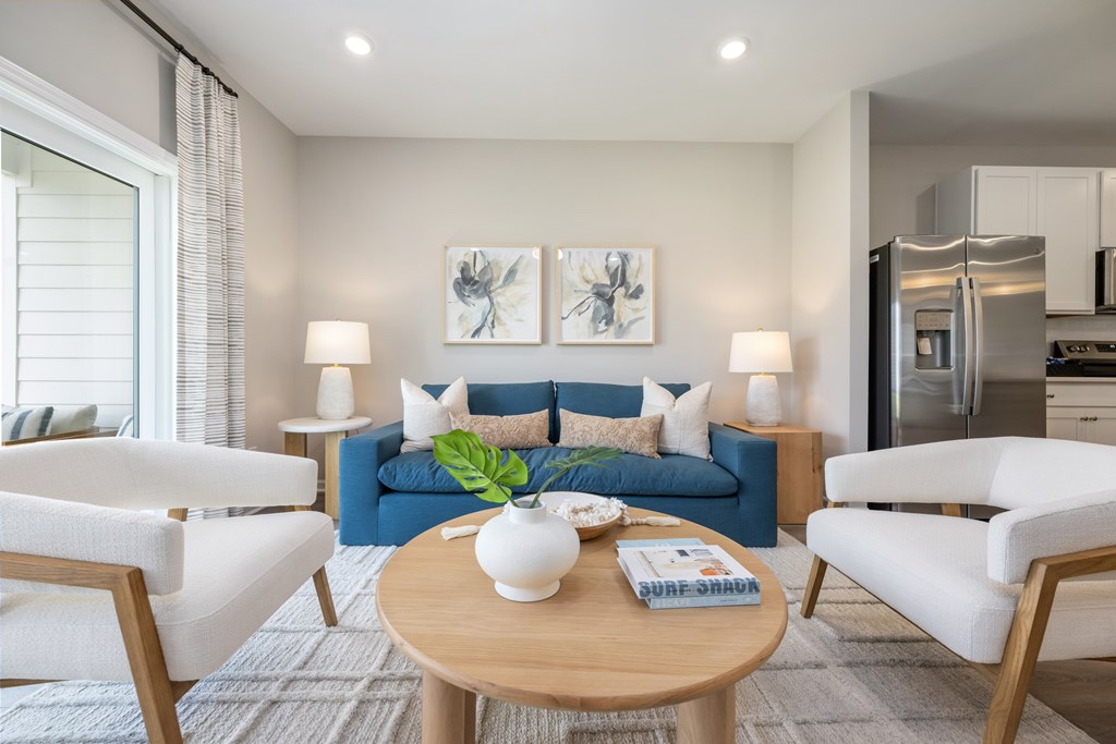 A modern living room with a blue couch and a coffee table.