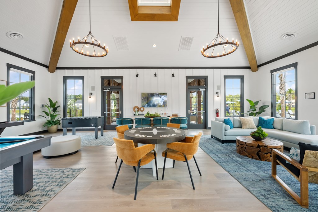 A modern living room with a pool table and a dining table.