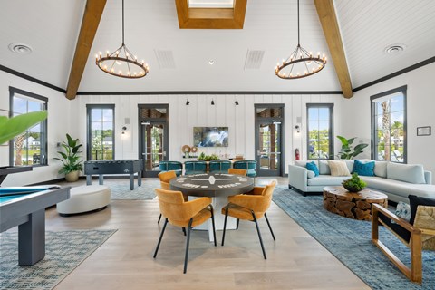 A modern living room with a pool table and a dining table.