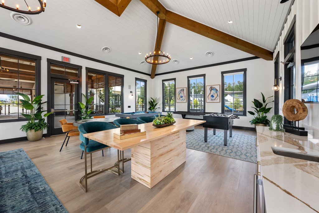 A modern office space with a wooden reception desk and blue chairs.