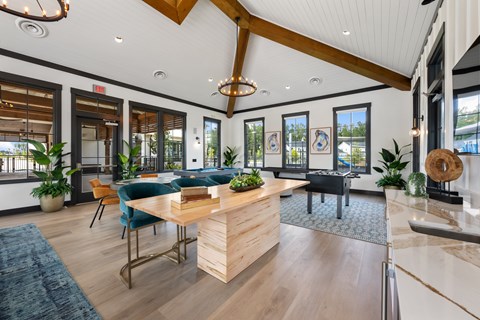 A modern office space with a wooden reception desk and blue chairs.