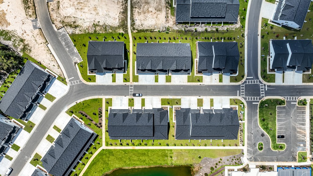 A bird's eye view of a residential area with houses and roads.