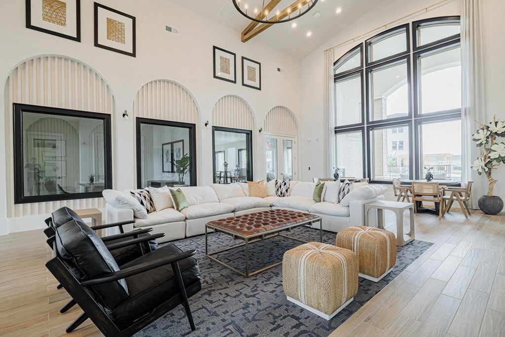 a living room filled with furniture and a large window