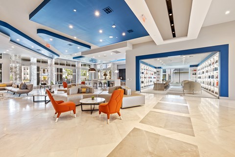 A spacious interior with orange chairs and a white sofa.