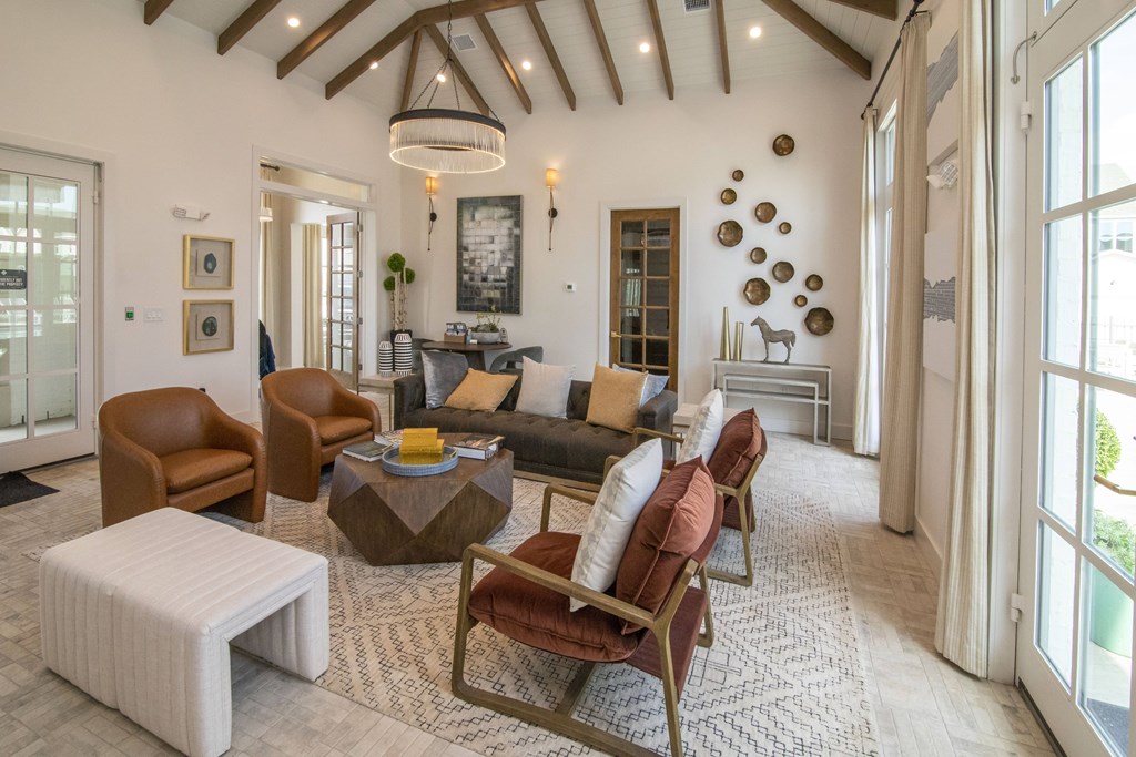 A living room with brown and white furniture and a large window.
