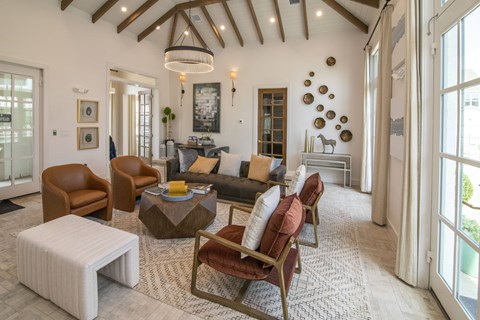 A living room with brown and white furniture and a large window.