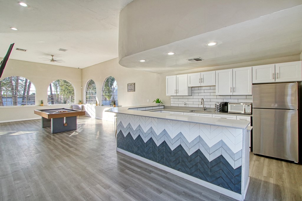 a large kitchen with a pool table and a billiards table