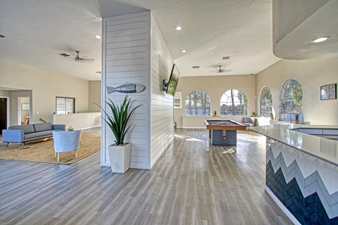a spacious lobby with a pool table and a flat screen tv
