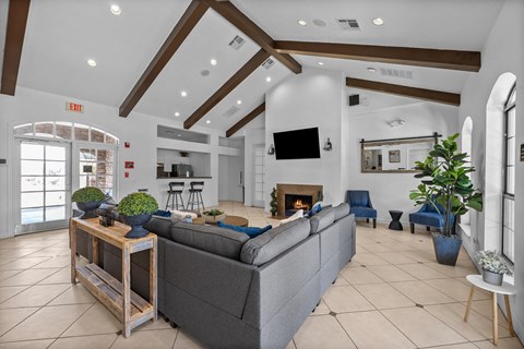 the living room of a house with a large couch and a fireplace
