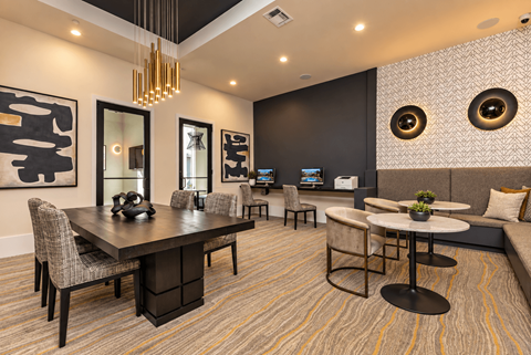 A modern dining room with a large table and chairs.