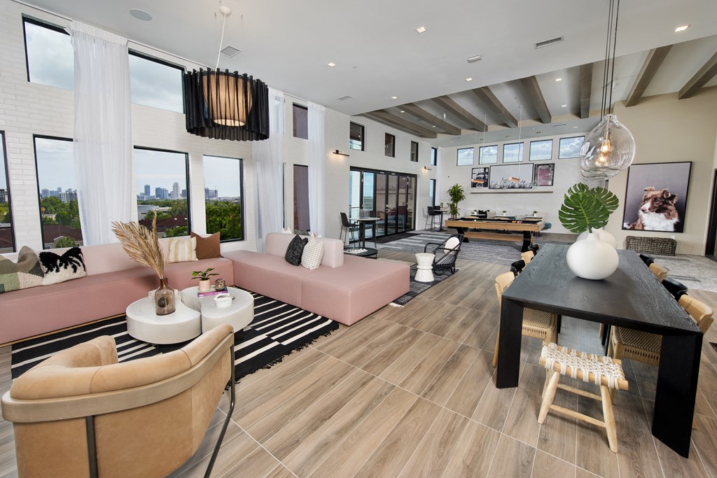 a living room with couches and a table with a ping pong