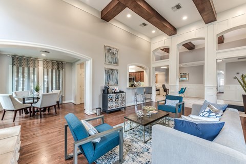 A living room with a blue couch and a coffee table.