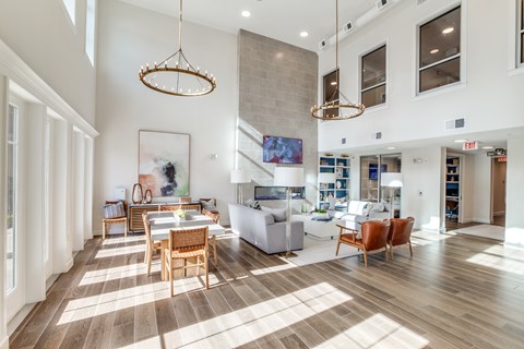 A large open living room with a dining table and chairs.