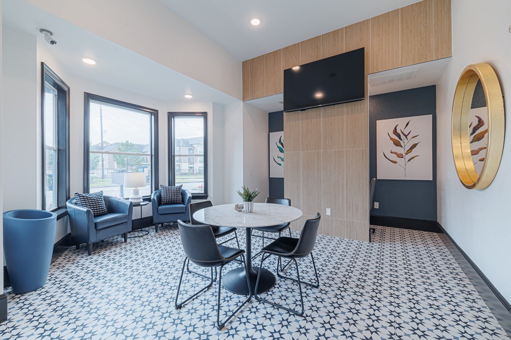 A dining area with a round table and chairs.