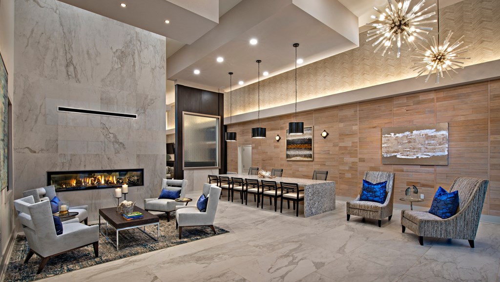 a living room with a fireplace and a table with chairs