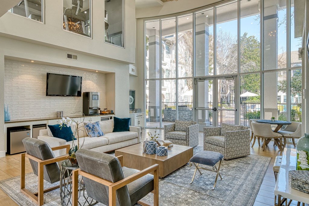 a living room with couches and chairs and a television