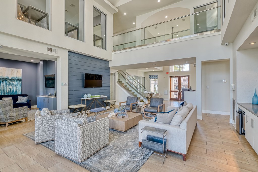 a living room with couches and chairs and a television